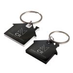 Two house-shaped keytags in black and white, featuring a keyring and a logo on each.