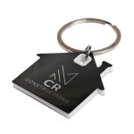 A keytag shaped like a house in black and white, featuring a circular keyring and a logo.