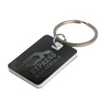 A rectangular stainless steel keytag with a keyring, featuring a dark design and a logo.