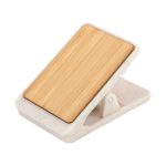 A magnetic clip with a bamboo top and a white base, featuring a logo. Ideal for office use and organising papers.