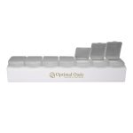 A white weekly pill box featuring multiple clear compartments and a logo.