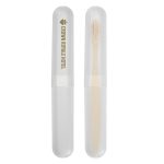 A toothbrush case featuring a transparent exterior and a bamboo toothbrush inside, labeled with "Crown Royale Hotel."