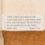 A cork and cotton utility case in a beige color with natural textures. Features a label with care instructions.