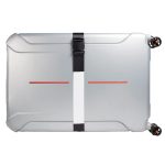 A luggage strap secures a silver suitcase, featuring a minimalistic design with a central white stripe and red accents.