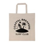 A cream-colored tote bag with a black logo featuring a palm tree, surfboard, and birds. It has short handles.