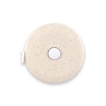 A beige circular tape measure with a smooth surface and a central button, featuring a logo.