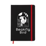 A black A5 notebook featuring a graphic design on the cover, secured with a red elastic band.