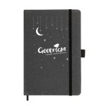 A black recycled leather notebook with a moon and star design, featuring an elastic closure and a logo.