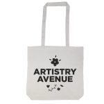 A tote bag with a long handle featuring the text "ARTISTRY AVENUE" and decorative floral elements.