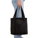 A black cooler bag is being held by a person, featuring sturdy handles and a simple design.