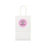 A small white paper bag with handles and a circular logo in pink on the front.