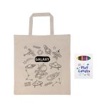 A beige calico bag featuring space-themed designs and a box of colorful crayons beside it. The bag has short handles.