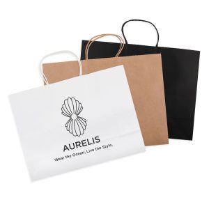 A set of three extra-large paper bags in white, brown, and black, each with handles and a logo.