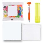 An assortment of colorful jelly beans, an orange and silver pen, a lime green lip balm, a white cloth, and a clear pouch.
