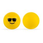 A pair of yellow stress balls featuring a smiling emoji with sunglasses on one side and a plain surface on the other.