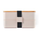 A Stax Eco Lunch Box in soft pink with a bamboo lid and a black elastic strap for secure closure.