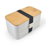 A two-tiered lunch box in white with a bamboo lid, secured by a black elastic band and featuring a branded logo.