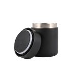A black food container with a removable lid, featuring a stainless steel inner lining for insulation.