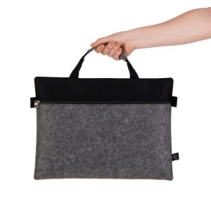 A grey felt satchel with a black top, featuring a zippered closure and dual handles.