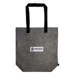 A gray tote bag with black handles featuring a printed logo label that reads "NOMADSCAPE."