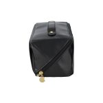A black toiletry bag featuring a zip closure, gold accents, and a structured design. It has a logo.