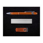 A gift set featuring an orange pen, a silver card holder, and an orange USB flash drive, all on a black background.