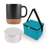 A black coffee mug with a cork base, a silver speaker, and a teal carrying bag.