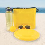 A drink bottle, a frisbee, a yellow ball, and a pair of sunglasses are arranged alongside a bright yellow cooler bag.
