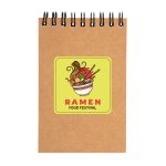 A spiral-bound notebook in brown with a vibrant ramen-themed design on the cover.
