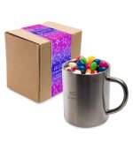 A Java mug filled with assorted color mini jelly beans, placed next to a packaged box.