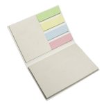 A sticky note booklet featuring pastel-colored notes including green, yellow, blue, and pink on a neutral background.