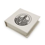 A square gift box in a light cream colour, featuring a logo on the lid.