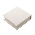 A square, white note block with a textured finish, featuring a logo on the top.
