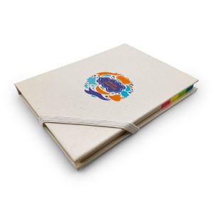 A cream-coloured planner with a colourful logo and a rubber band closure, featuring multicoloured tabs on the side.
