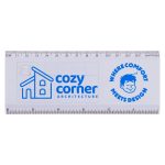 A transparent ruler featuring a blue logo, marked in centimetres and inches, with a whimsical design element.