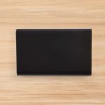 A sleek black Octavius 8,000mAh Power Bank is displayed on a wooden surface.