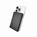 A black solid-state power bank is positioned against a silver smartphone, highlighting its sleek design and portable size.