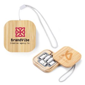 A square, bamboo charging cable set with a logo, featuring various connectors and a lanyard for easy carrying.