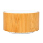 A bamboo Bluetooth speaker featuring a sleek, cylindrical design with a light wood finish.
