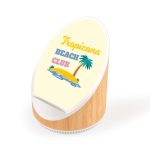 A wireless speaker and charger in white and bamboo finish with a vibrant beach-themed design featuring a palm tree.