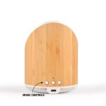 A wireless speaker with a bamboo finish featuring music control buttons and a charging port at the bottom.