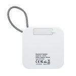 A white Bluetooth speaker with a textured strap and branding on the back. The speaker features a flat, square design.