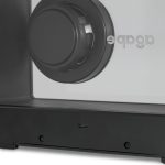 A black speaker with a circular driver, featuring a minimalistic design and a visible logo.