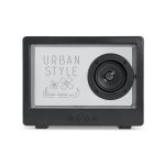 A black speaker featuring a front design with flowers and geometric shapes, including a prominent circular speaker.