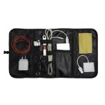 A black organizer containing various cables, chargers, and a cleaning cloth in a compact, zippered design.