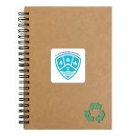A brown spiral notebook with a green recycling symbol and a logo on the cover.