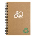 A brown spiral-bound notebook with a green recycling symbol and a logo on the cover.