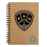 A brown spiral-bound notebook with a shield design and a recycling symbol at the bottom.