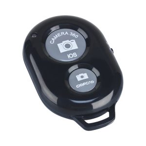 A black selfie button remote featuring two buttons for camera activation, with a logo on the surface.