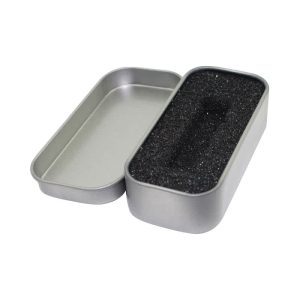 A silver tin box with a removable lid, featuring a black foam interior for pen packaging.